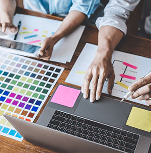 hands-on-laptop-and-with-pen People providing customer experience consulting services us